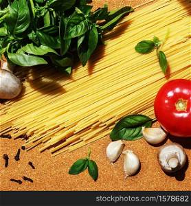 ingredients for cooking Italian pasta on a cork board