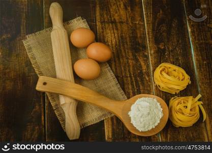Ingredients for cooking pasta on rustic wood