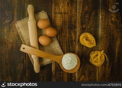 Ingredients for cooking pasta on rustic wood