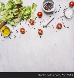 Ingredients for cooking Vegetarian Food, lettuce, cherry tomatoes, oil, salt and pepper on wooden rustic background top view close up border ,place for text