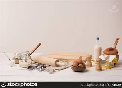 Ingredients for dough on white wooden table