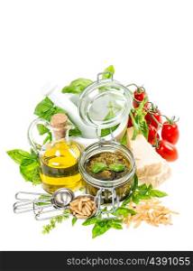 Ingredients for fresh green pesto sauce on white background. Olive oil, basil, parmesan, tomato