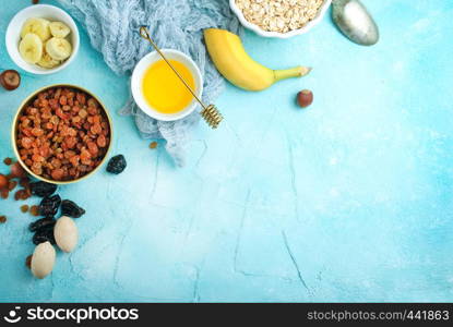 ingredients for helthy breakfast, raw oat flakes with banana and nuts