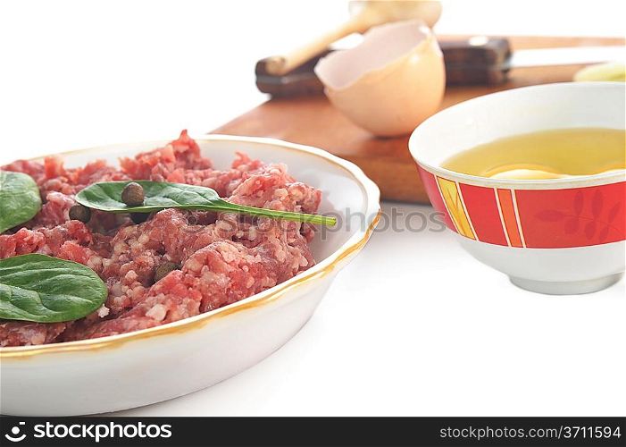 Ingredients for homemade cutlet, ground beef, onion, eggs and garlic.