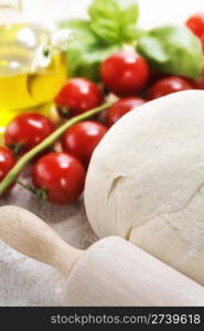 ingredients for homemade pizza(dough, cheese, olive oil and vegetables)