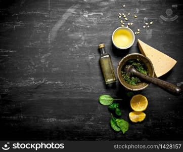 Ingredients for Italian pesto. On the black wooden table.. Ingredients for Italian pesto.