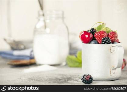 Ingredients for making berry jam on rustic background
