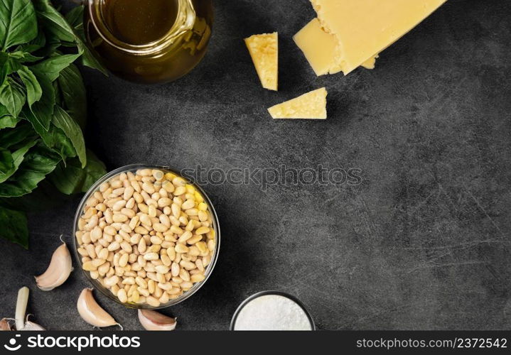 Ingredients for making pesto sauce on a gray kitchen table. View from above