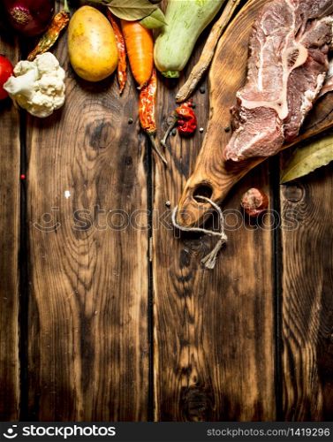 Ingredients for making soup with beef. On wooden background.. Ingredients for making soup with beef.
