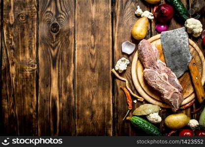 Ingredients for making soup with beef. On wooden background.. Ingredients for making soup with beef.