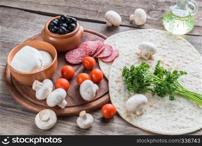 Ingredients for pizza on the wooden background