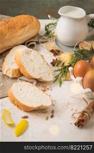Ingredients for preparing spanish torrijas, french toasts  or traditional Portuguese rabanadas for Christmas. Typical sweet food for Christmas made with slices of bread, eggs, cinnamon, milk and lemon peel