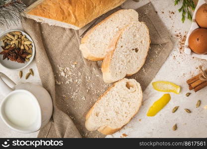 Ingredients for preparing spanish torrijas, french toasts  or traditional Portuguese rabanadas for Christmas. Typical sweet food for Christmas, New Year, Lent and Easter made with slices of bread, eggs, cinnamon, cardamom, anise star, milk and lemon peel