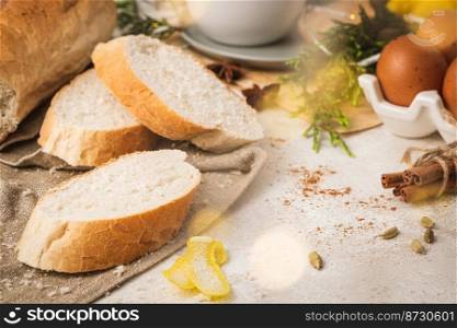 Ingredients for preparing spanish torrijas, french toasts  or traditional Portuguese rabanadas for Christmas. Typical sweet food for Christmas made with slices of bread, eggs, cinnamon, milk and lemon
