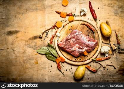 Ingredients for soup with pork. On wooden background.. Ingredients for soup with pork.