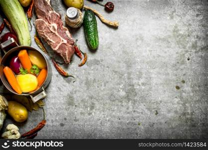 Ingredients for soup with vegetables, spices and meat. On the stone table.. Ingredients for soup with vegetables, spices and meat.