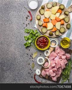 Ingredients for the stew with turkey and vegetables border ,place for text on wooden rustic background top view close up