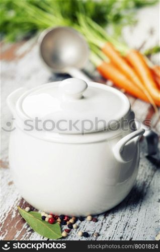 Ingredients for vegetable (vegetarian) soup and cooking pot on vintage background