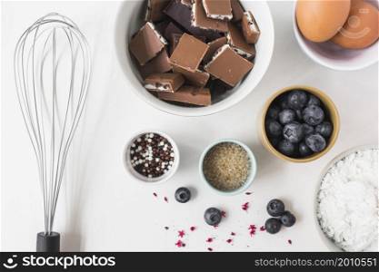 ingredients making cake with whisk white background