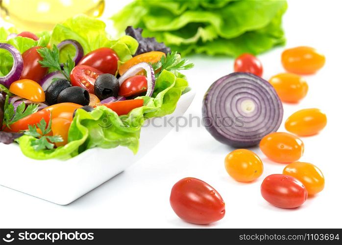 Ingredients of healthy vegetable lettuce - lettuce, olive oil, olives, tomatoes, onion, parsley.