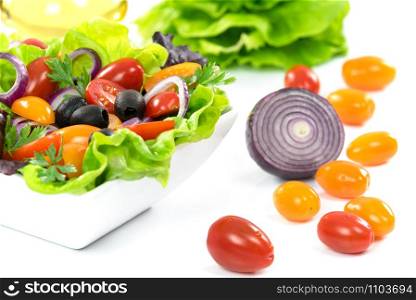 Ingredients of healthy vegetable lettuce - lettuce, olive oil, olives, tomatoes, onion, parsley.