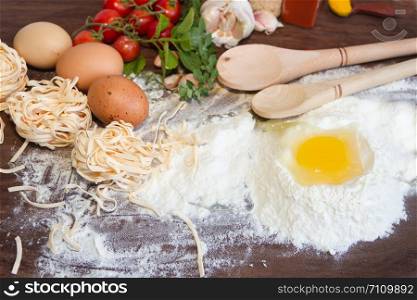 ingredients preparation spaghetti with eggs, tomatoes herbs and spices