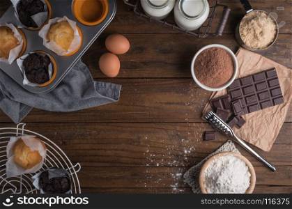 Ingredients to cooking muffins in a rustic setting on wooden table with copyspace