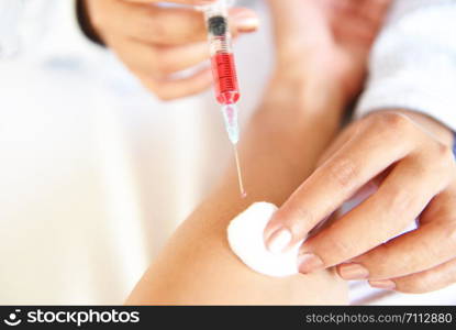 injection medicine by nurses are vaccine to patients in hospital / Doctor giving patient in arm using the syringe healthy and medical concept , selective focus