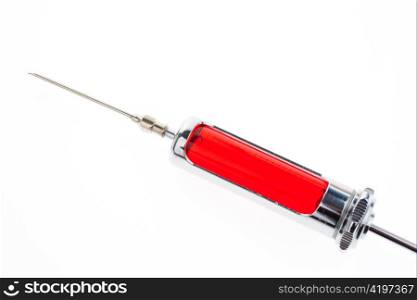 injection needle and syringe with red fluid on a white background.