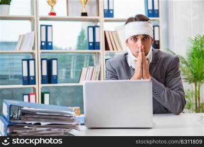 Injured businessman working in the office. The injured businessman working in the office