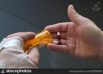 Injured Hand Holding Pill Bottle