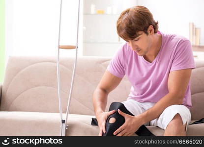 Injured man recovering at home from sports injury. The injured man recovering at home from sports injury