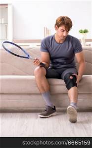Injured man recovering at home from sports injury. The injured man recovering at home from sports injury
