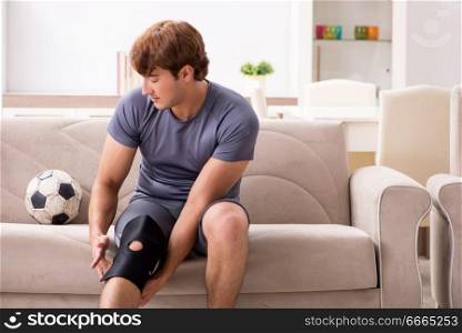 Injured man recovering at home from sports injury. The injured man recovering at home from sports injury