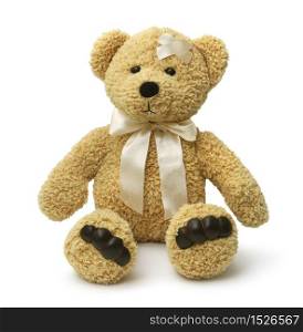 Injured teddy bear sitting sad on white background isolated. Sad teddy bear injured
