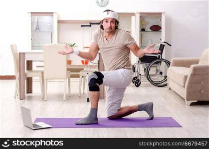 Injured young man doing exercises at home