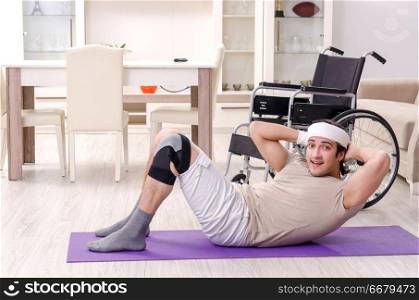 Injured young man doing exercises at home