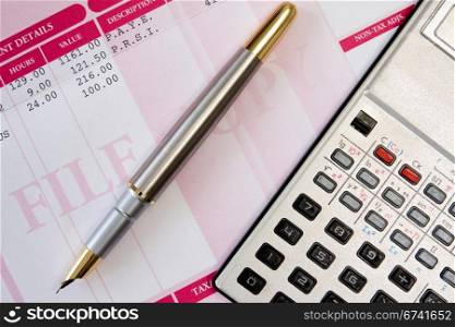 ink pen,calculator and payroll summary details