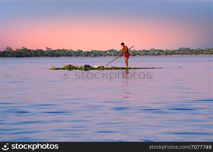 INLE LAKE, MYANMAR - NOVEMBER 15, 2015: Local worker collecting weed from the fresh water on Inle Lake, Myanmar on the 15th November, 2015