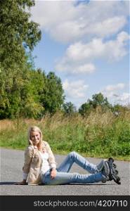 Inline skates young attractive woman wearing jeans sitting asphalt road