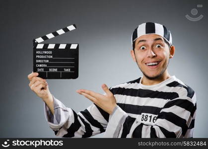 Inmate with movie clapper board