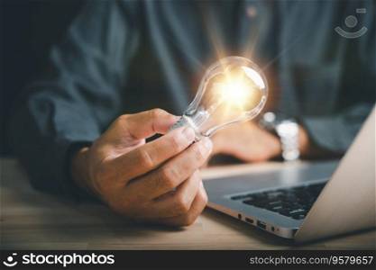 Innovation and inspiration, Businessman holds a creative light bulb, representing a new idea. Depicts the concept of brainstorming, solution, and successful profit in global business.