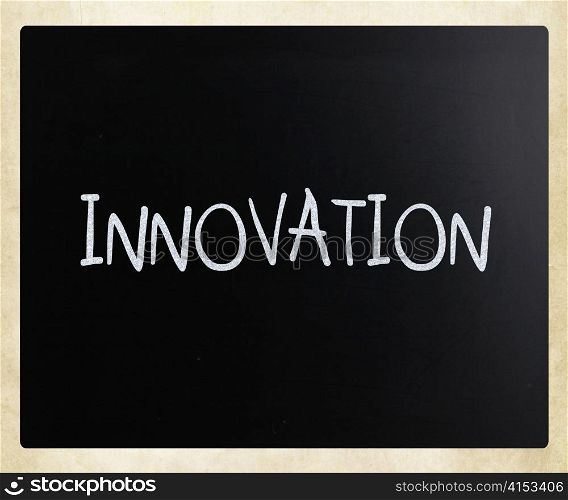 ""Innovation" handwritten with white chalk on a blackboard"