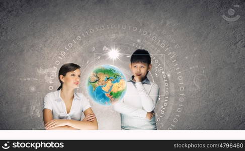 Innovation technologies in education. Woman teacher and boy at lesson touching media screen. Elements of this image are furnished by NASA