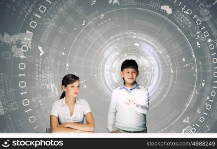 Innovation technologies in education. Woman teacher and boy at lesson touching media screen