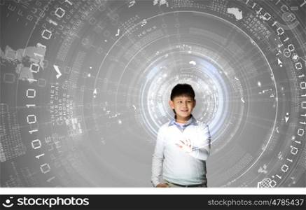 Innovation technologies in education. Young asian boy at lesson touching media screen