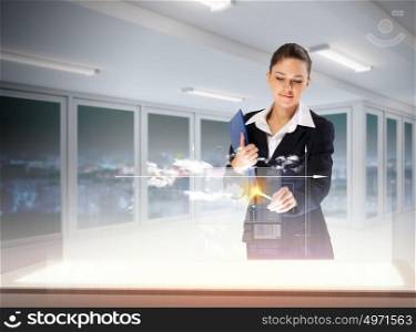 Innovations in business. Image of young businesswoman clicking icon on high-tech picture
