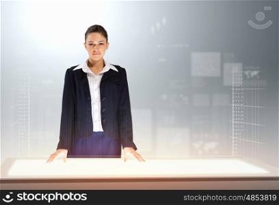 Innovations in business. Image of young businesswoman standing against high-tech picture background