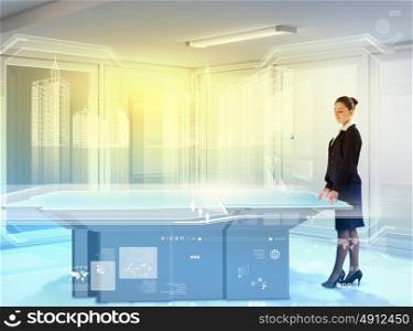 Innovations in business. Image of young businesswoman standing aside of high-tech picture