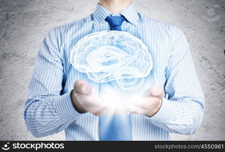 Innovations in medicine. Close up of businessman holding image of brain in hands